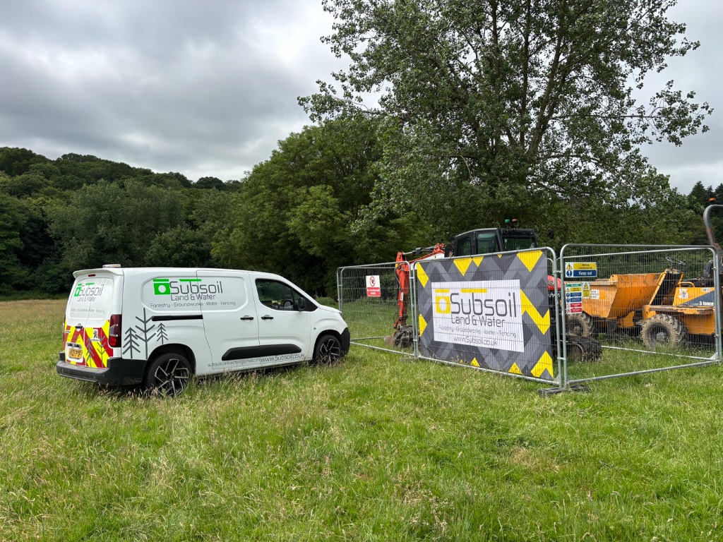 Subsoil Land & Water branded van and excavator on-site for large pond construction, ditching, specialist water management and wildlife area creation project in Battle, East Sussex — independent water management contractors