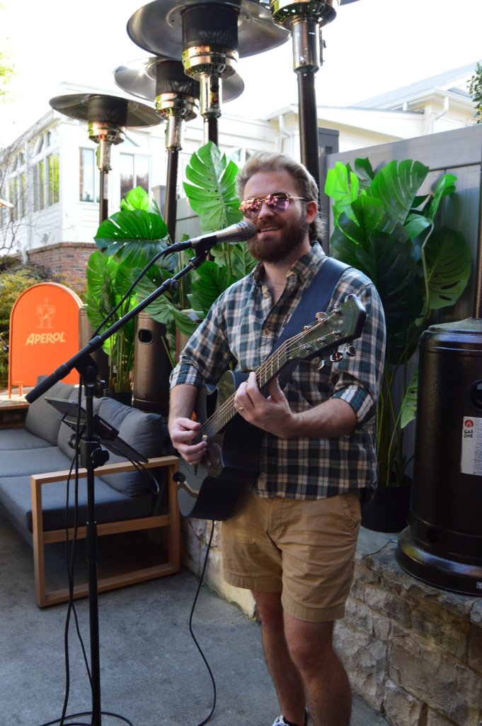 Live musician performing on stage with warm stage lighting