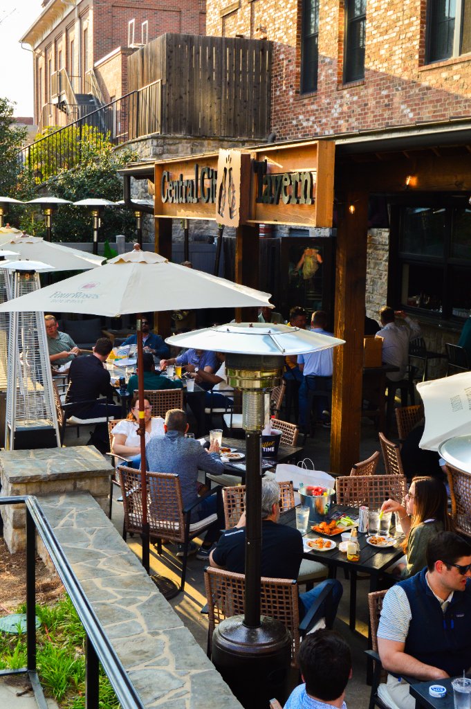 Outdoor patio at dusk with string lights and diners