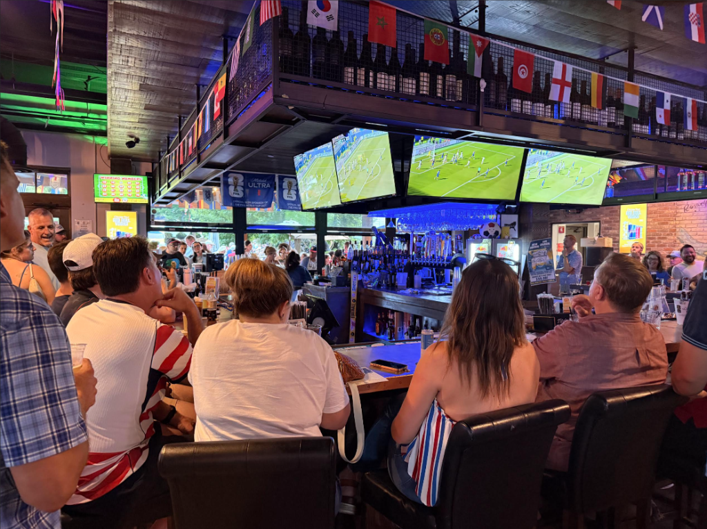 Sports fans celebrating a game at the tavern bar