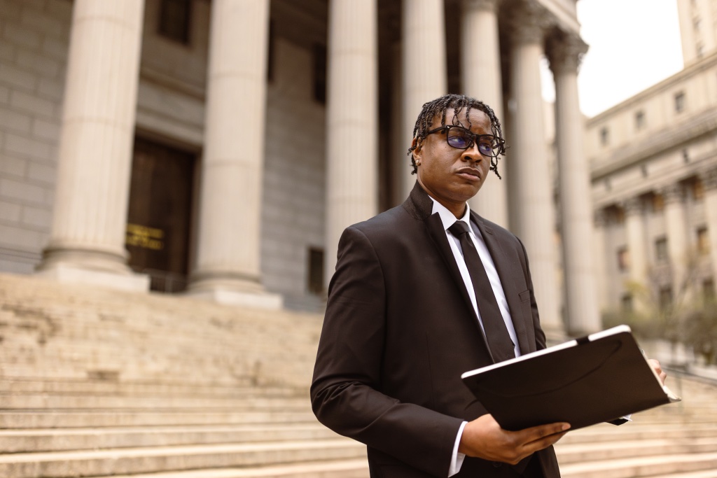 A man standing before courthouse columns