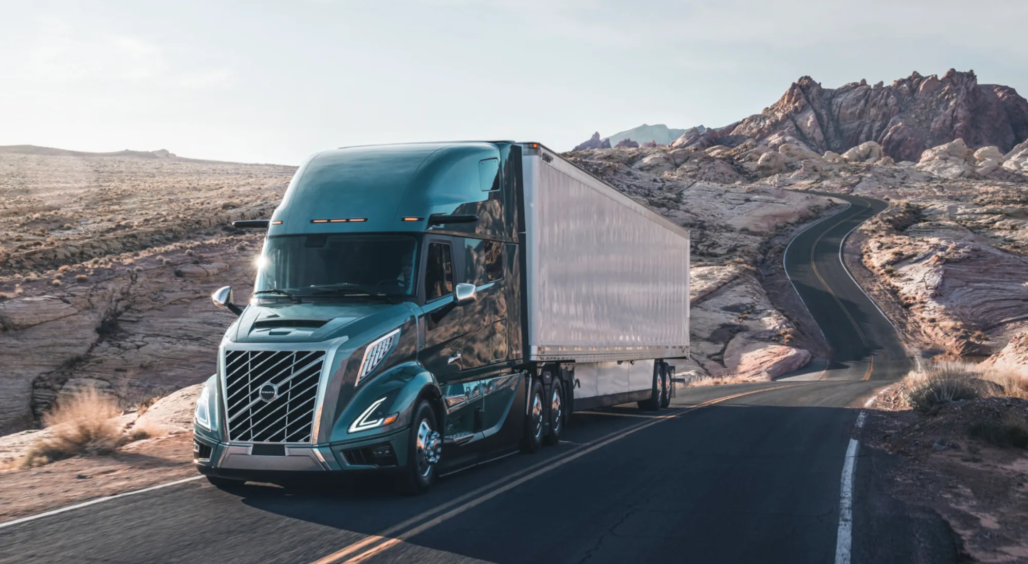 Modern semi truck on highway at dawn