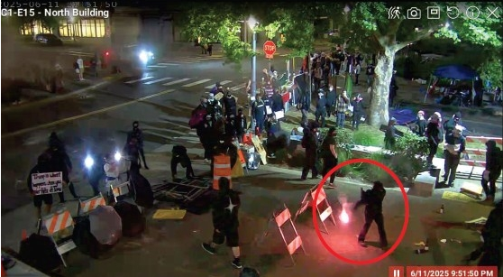 Barker throwing lit flare at ICE gate