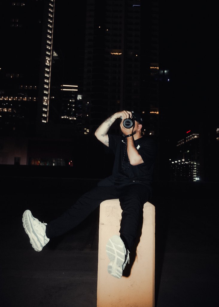 Chris shooting on a rooftop at night