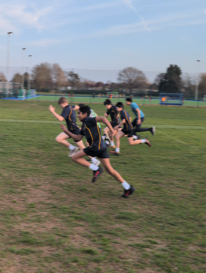 Young athletes sprinting during a club S&C session