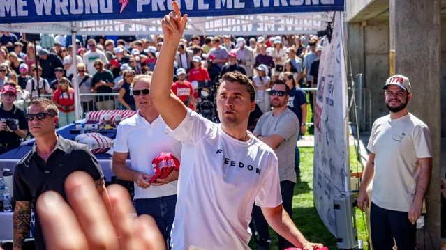 Charlie Kirk handing out caps at the UVU event