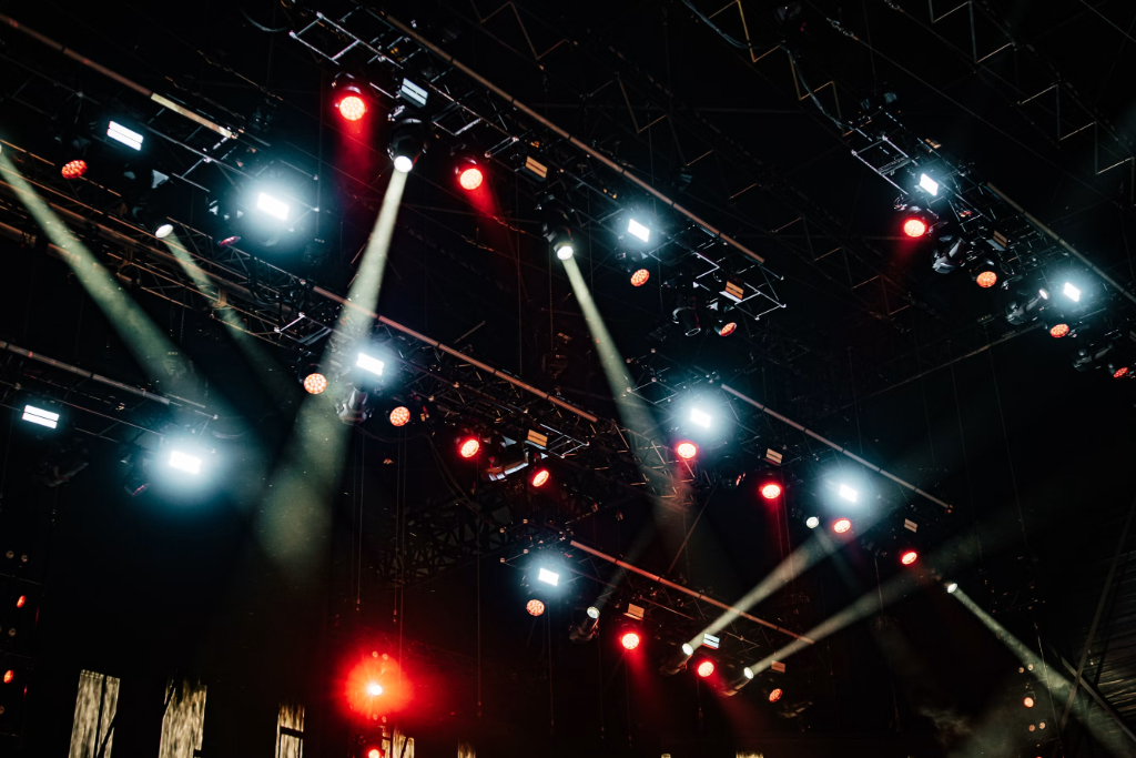 Theatrical stage lighting with colored spotlight beams through haze