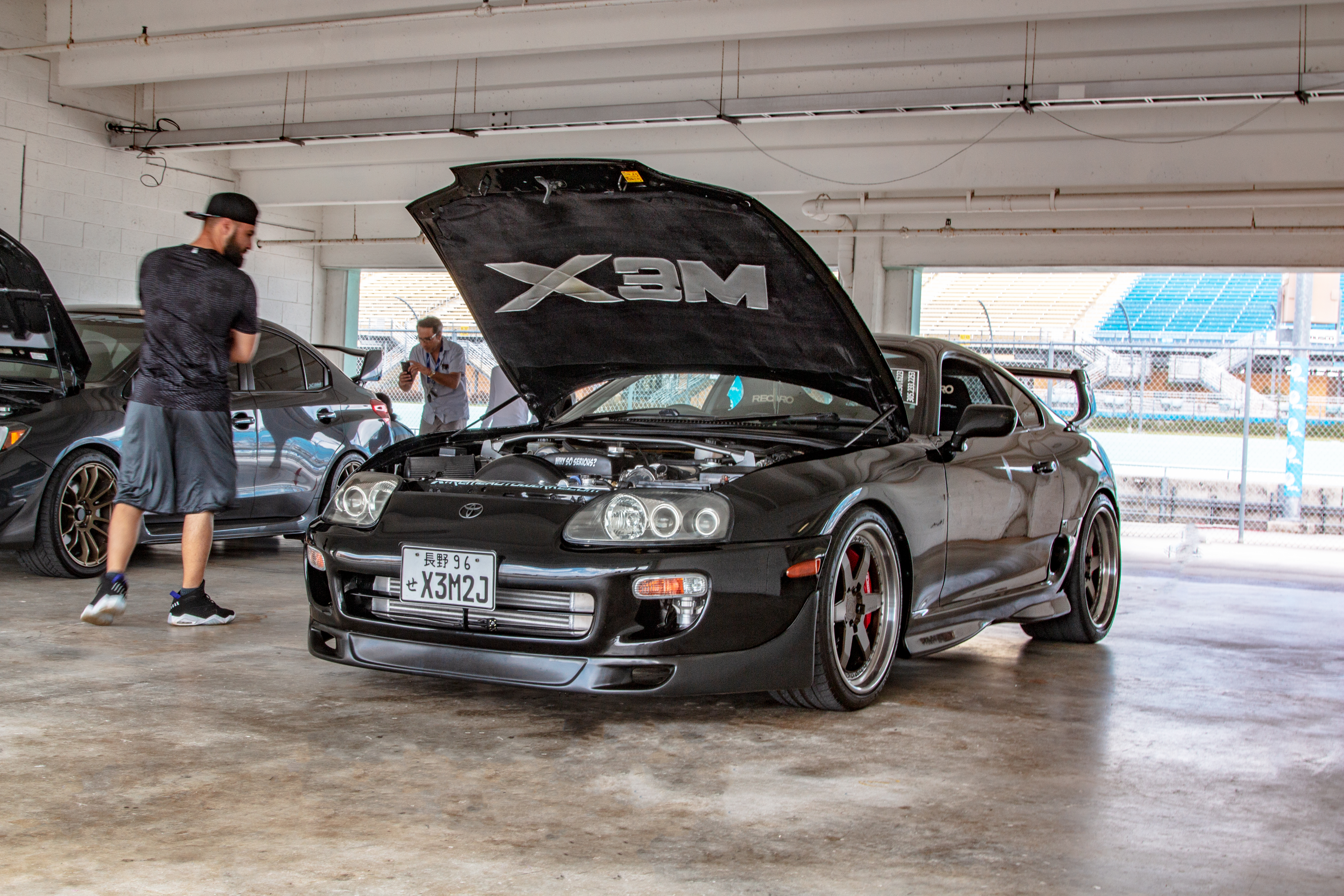 Black Toyota Supra with X3M hood logo in the shop