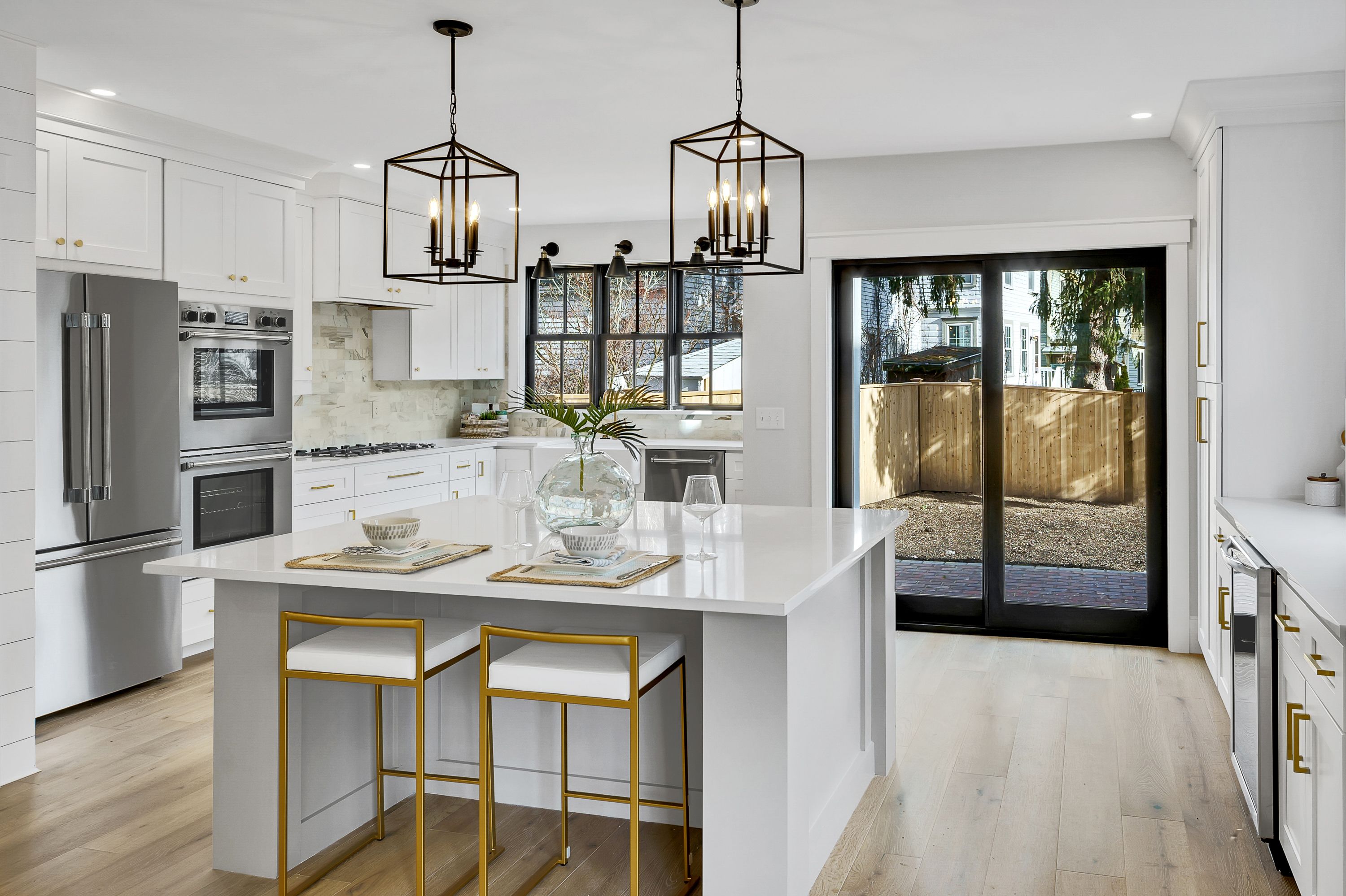 71 Federal — kitchen with white island, marble countertop, and black pendant lanterns