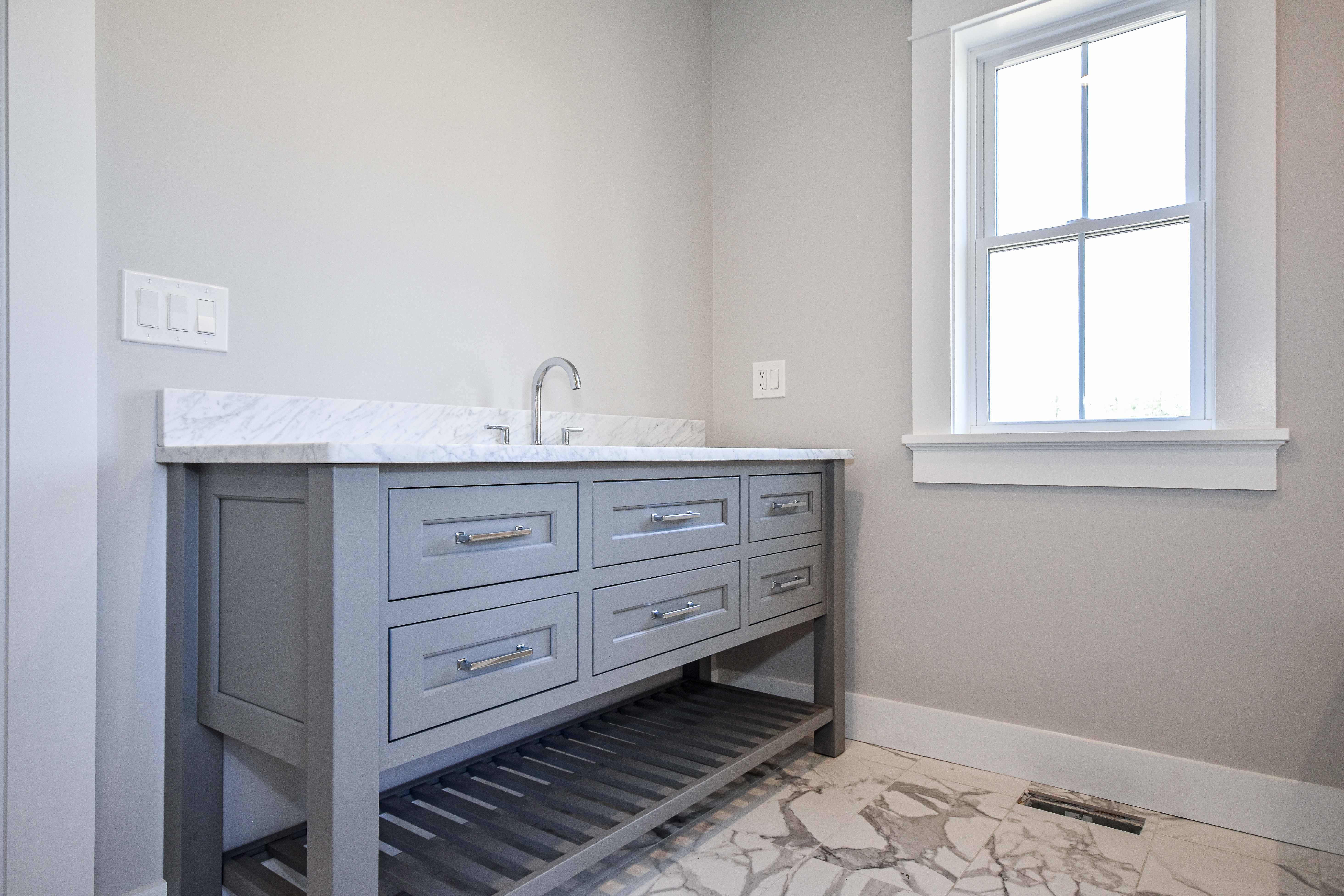 Kensington Kitchen — bathroom with grey vanity, marble countertop, and chrome faucet