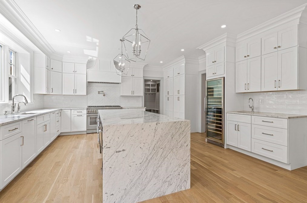 17 Arden — kitchen with white cabinetry, marble waterfall island, and wine refrigerator