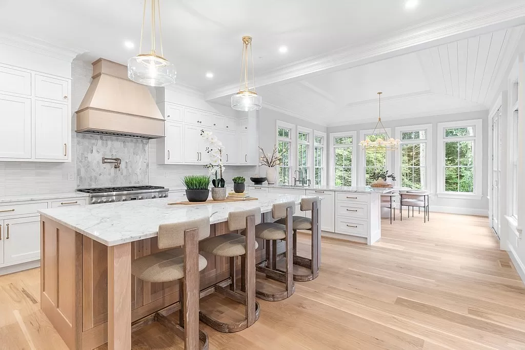 140 Whitman — kitchen with light wood island, marble countertop, and adjacent dining area