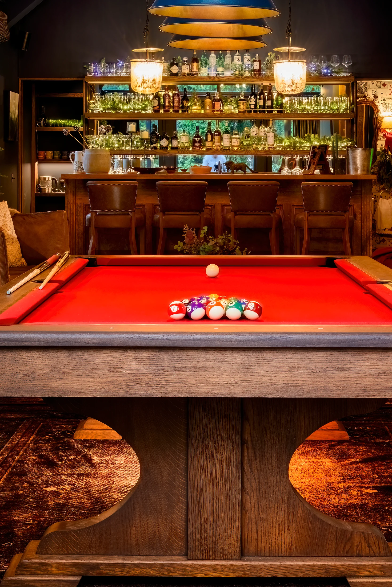 Luxury pool table with red felt in a sophisticated bar and games room