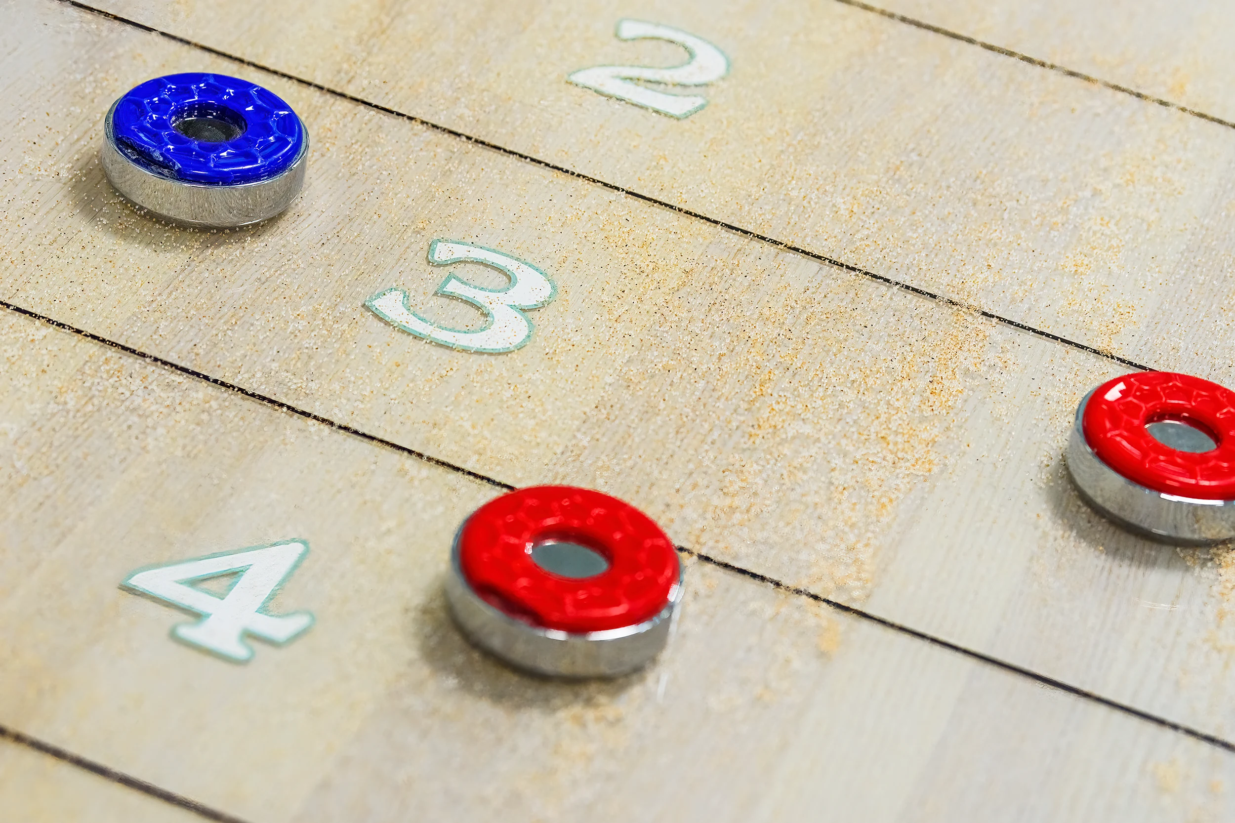 Professional weighted pucks specified for a handmade shuffleboard table