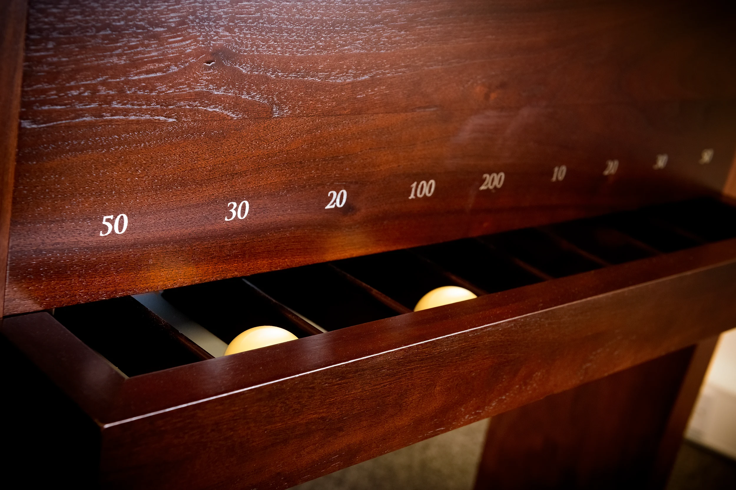 Inlaid timber scoring rail with billiard ball return on a bespoke pool table