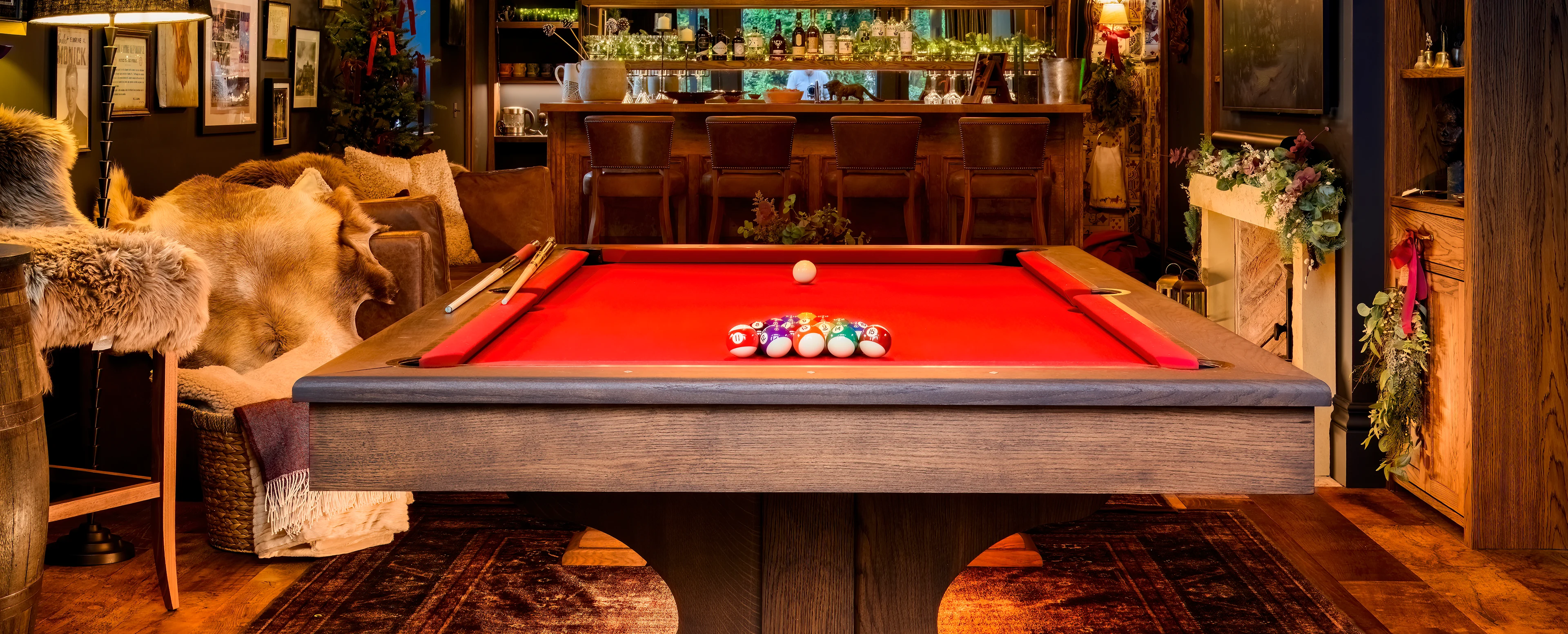 Luxury pool table handcrafted from solid walnut in a country house interior by French cabinet maker Bruno Boulay