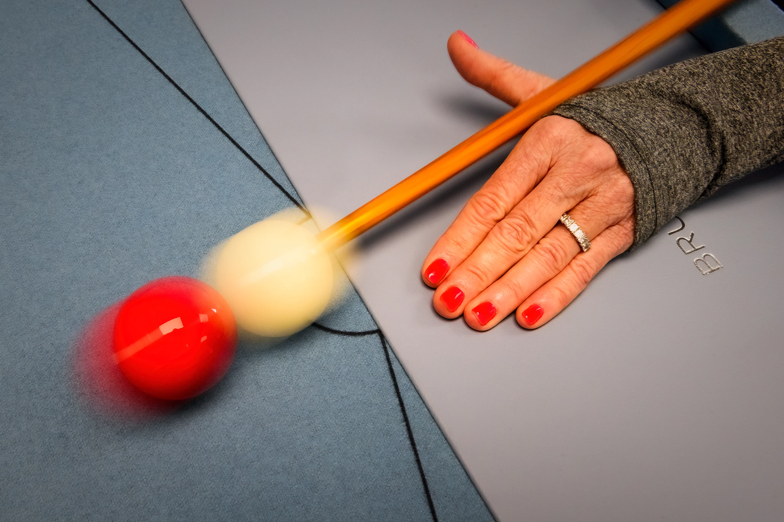 Bruno Boulay bespoke games table with cue striking a red ball on blue cloth