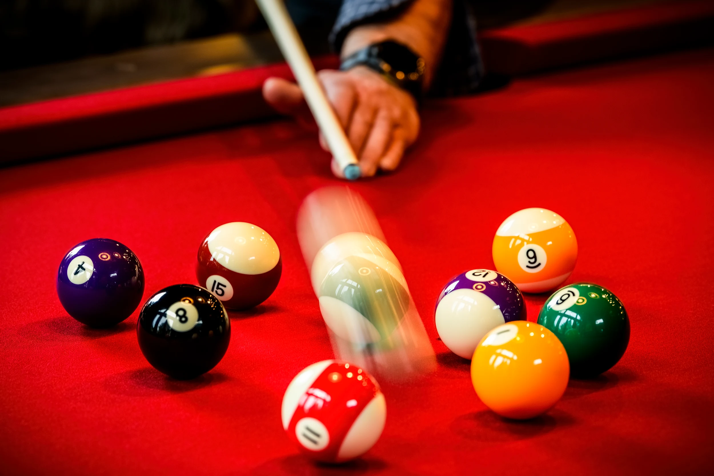 Professional slate bed beneath a handcrafted hardwood pool table