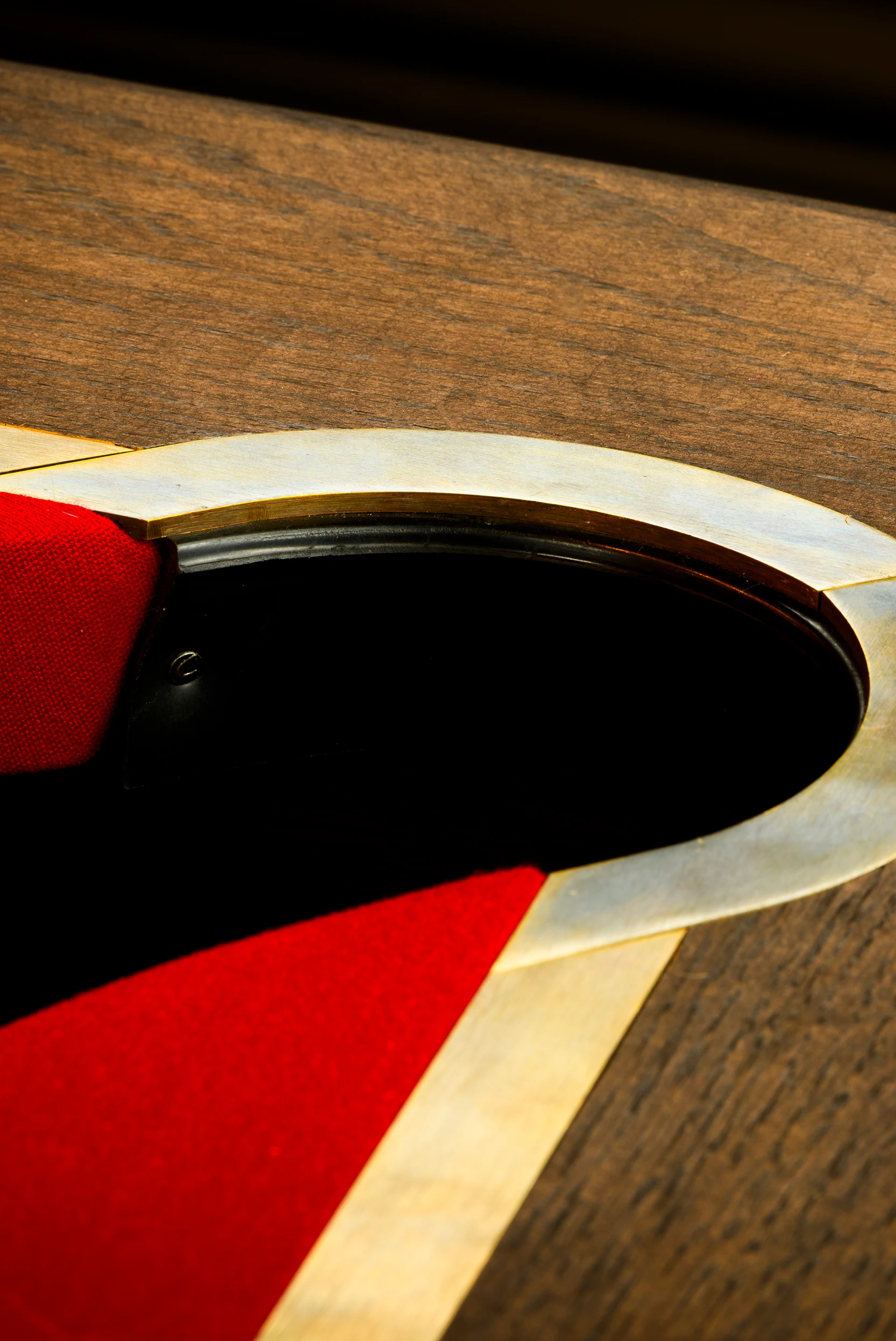 Brass pocket finishing on a handmade pool table