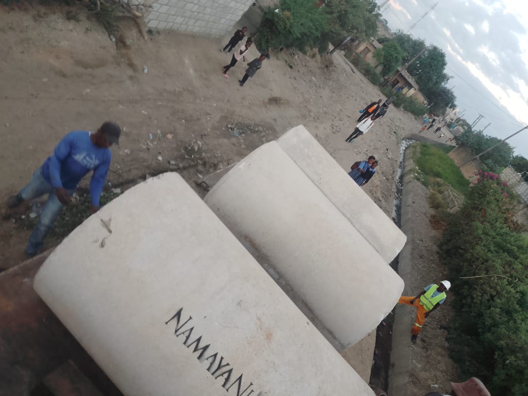 Namayani-branded concrete pipes loaded onto a flatbed truck