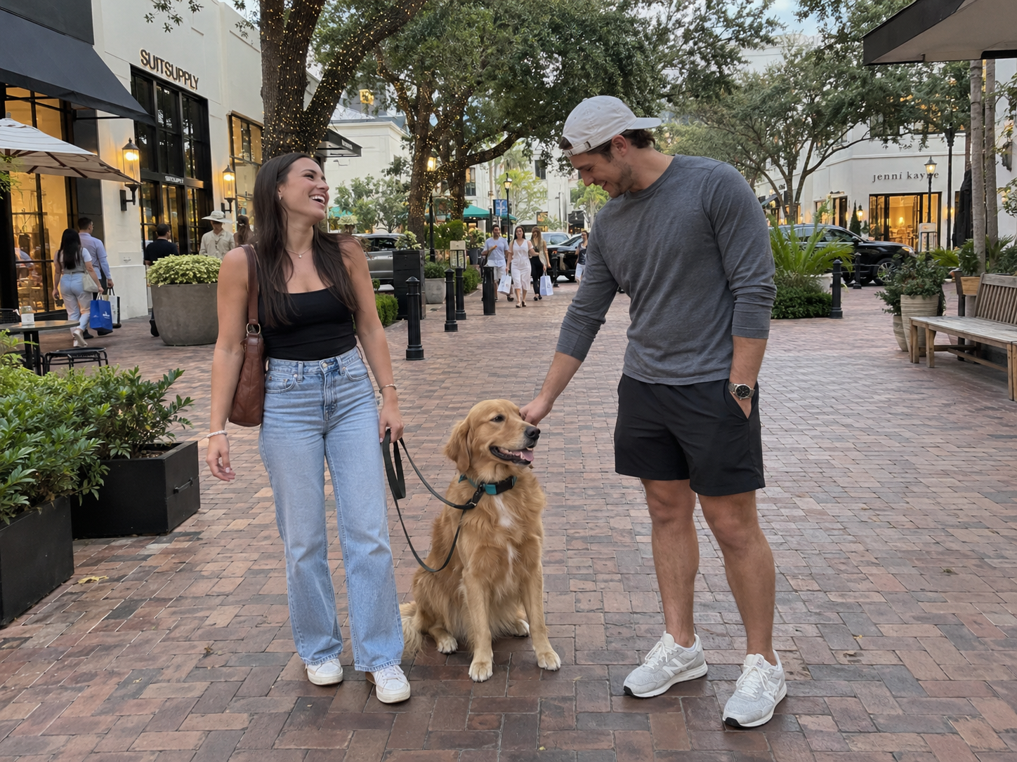 Handlers and a golden retriever practicing real-world manners in a public shopping district