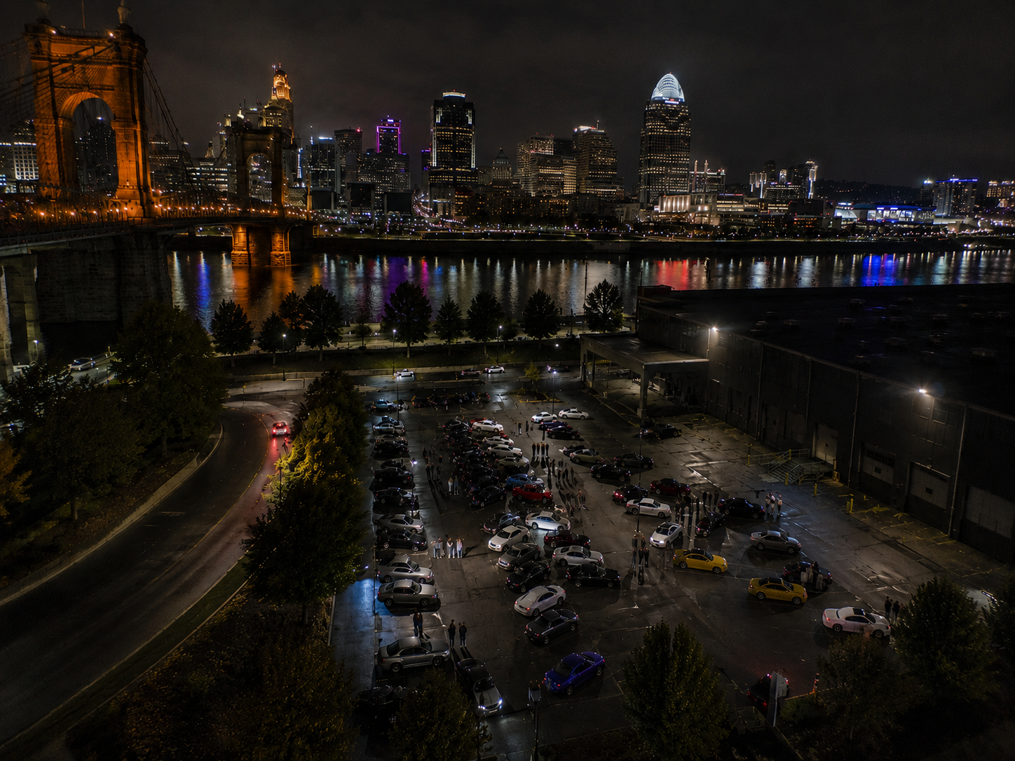 Car meet at night in downtown Cincinnati with neon reflections