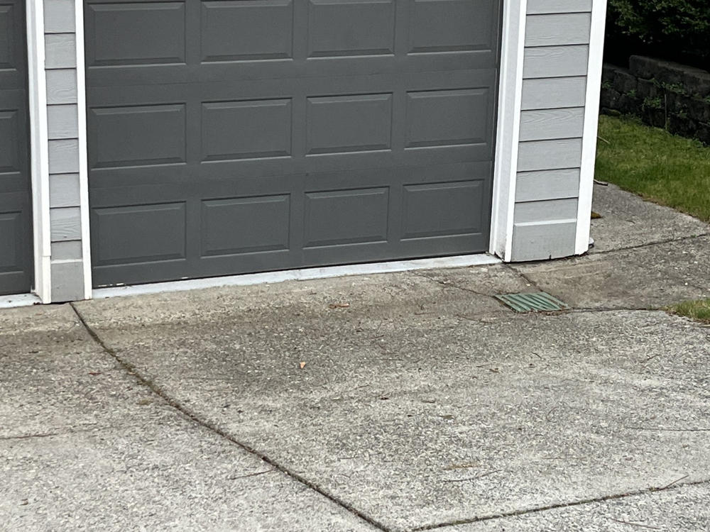 A clean garage exterior and driveway after a professional junk removal project in Bellingham.