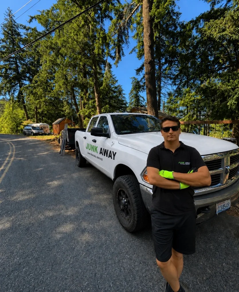 Max, owner of Junk Away, standing in front of his truck in Bellingham, WA