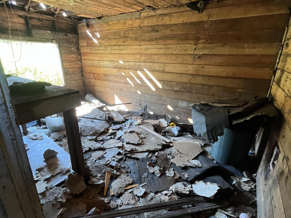 Debris scattered inside a dilapidated room undergoing demolition in Bellingham.
