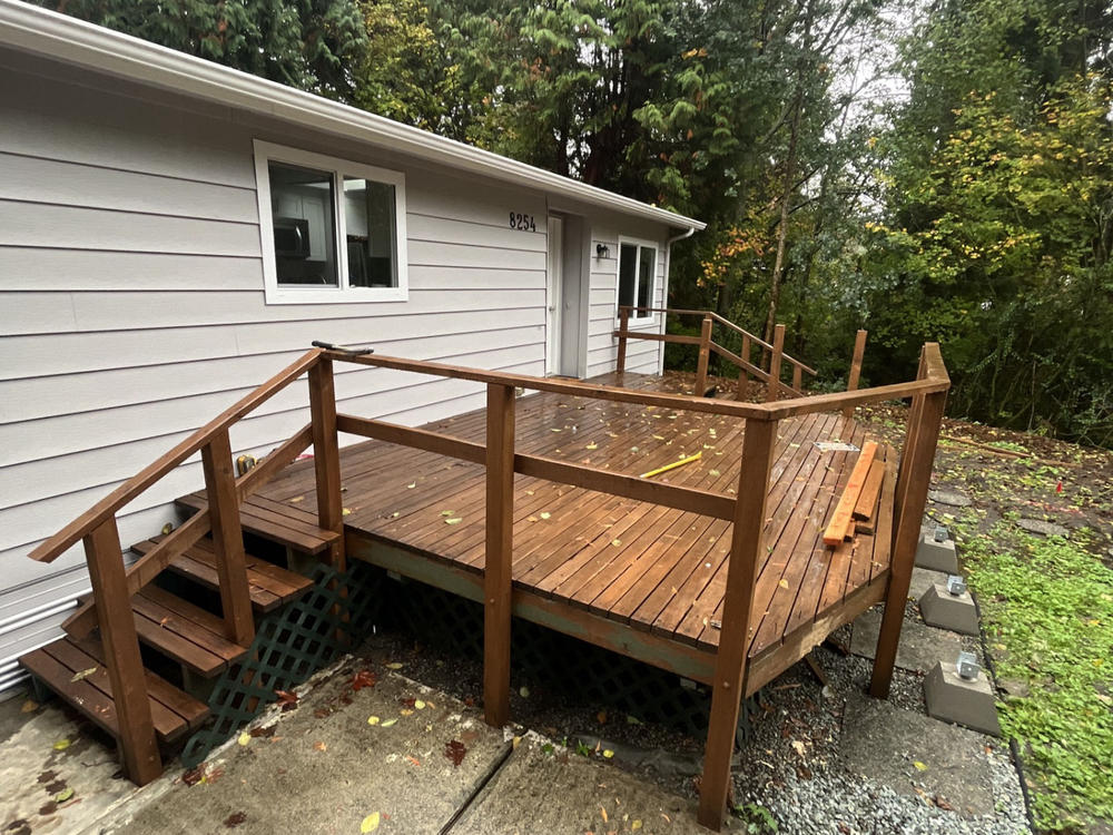 A wooden backyard deck partially disassembled during a demolition and junk removal project in Bellingham.