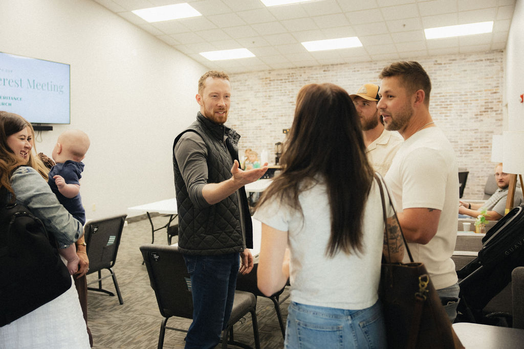 Members of Inheritance Church socializing together at an indoor gathering