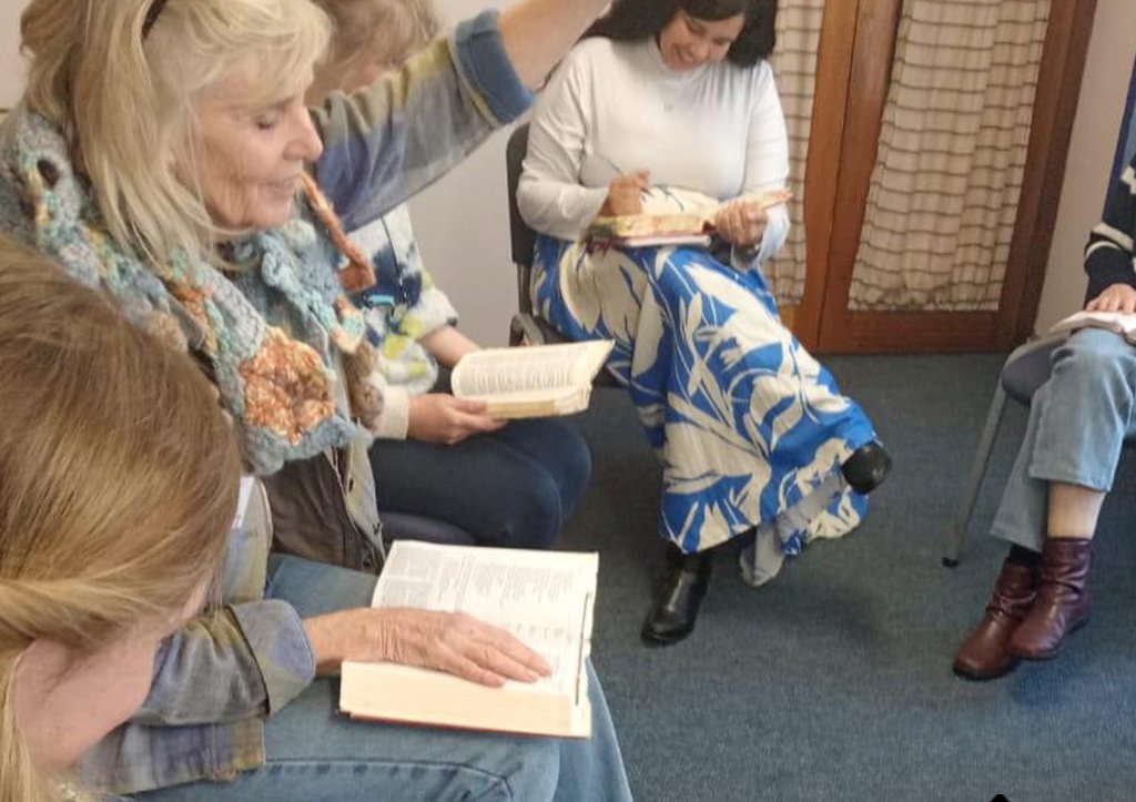 Group of people in a prayer vigil with golden light