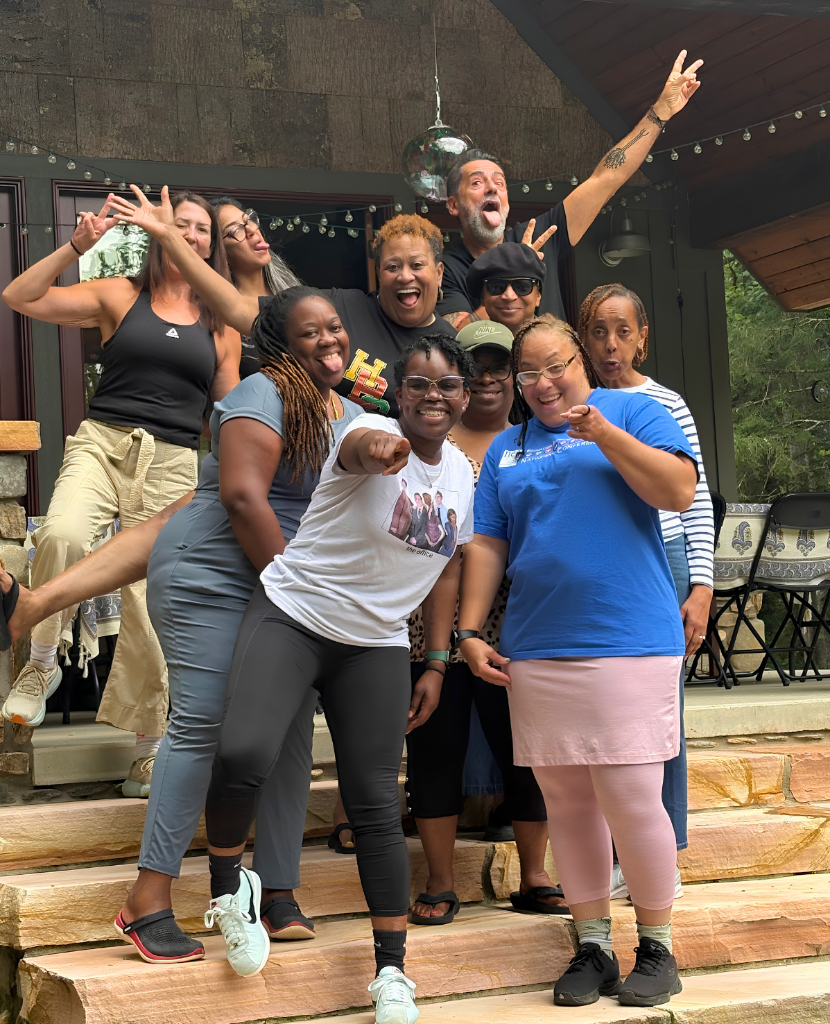 A group of educators posing together on stone stairs