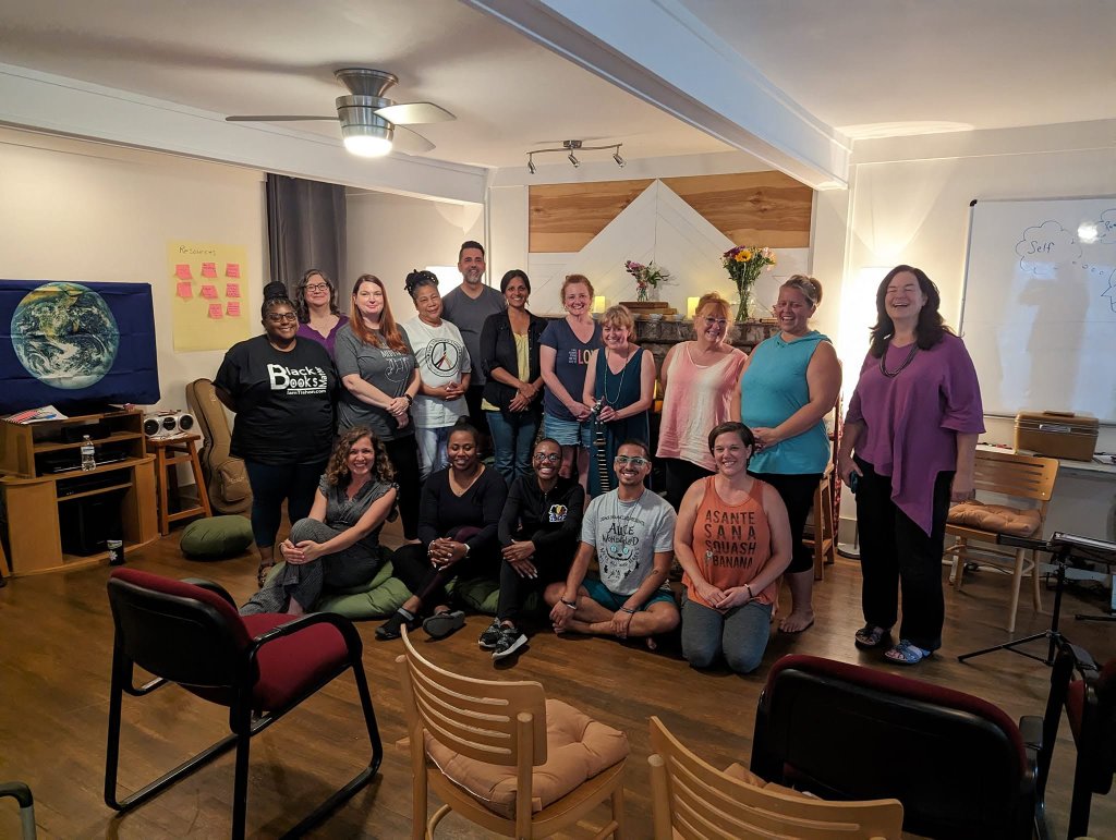 Center for Thriving retreat participants gathered together in a warm indoor setting