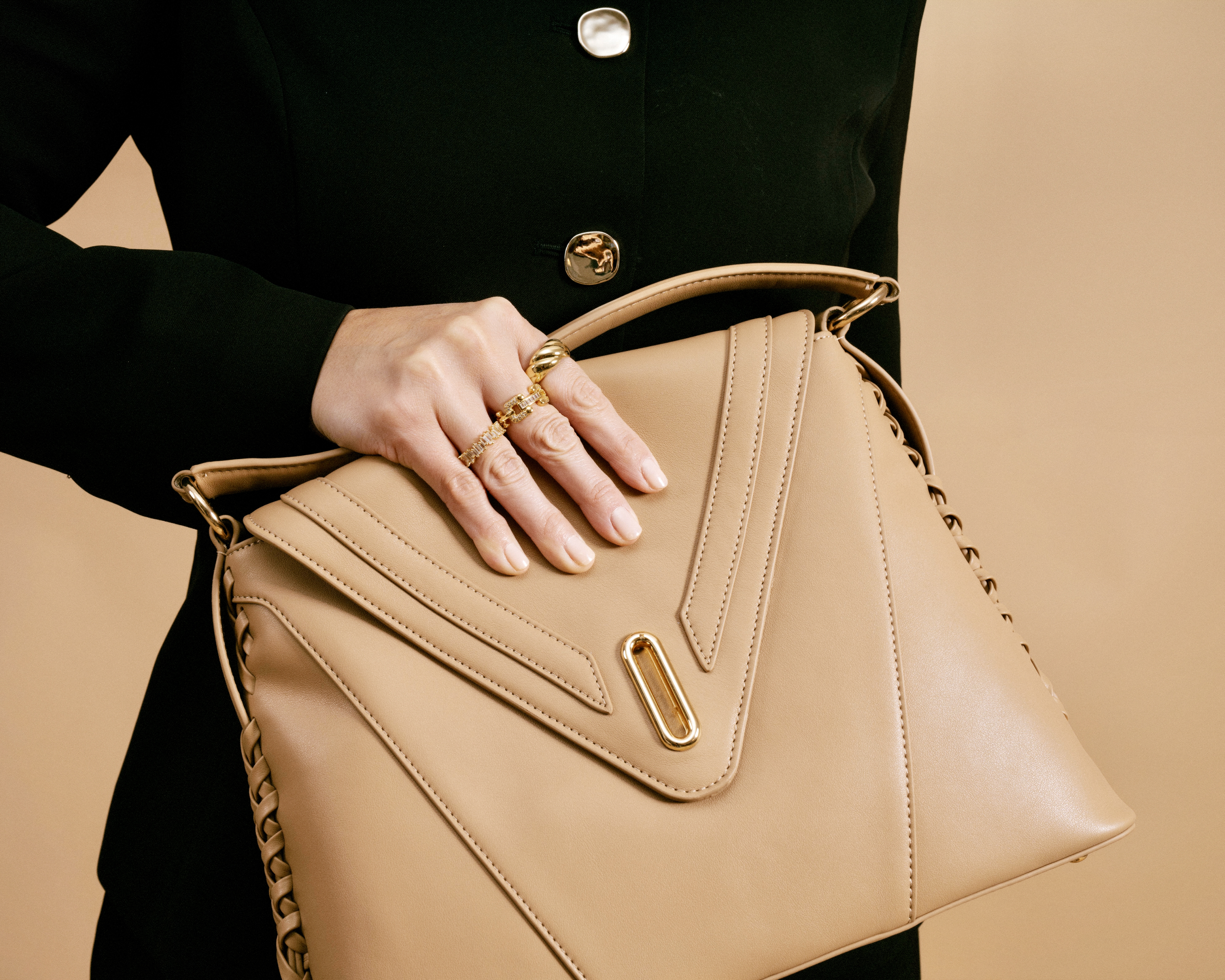 THE VESSEL held horizontally, revealing its complete silhouette, front construction, and curved handle.