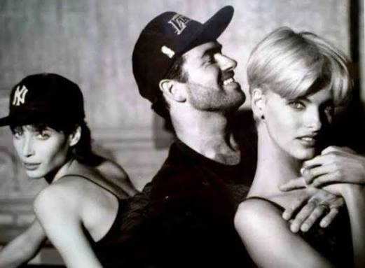 George Michael with fashion models in a studio portrait from the early 1990s