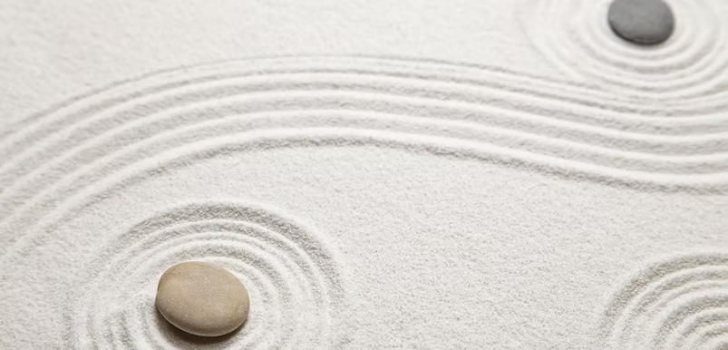 Zen garden raked sand with smooth stones