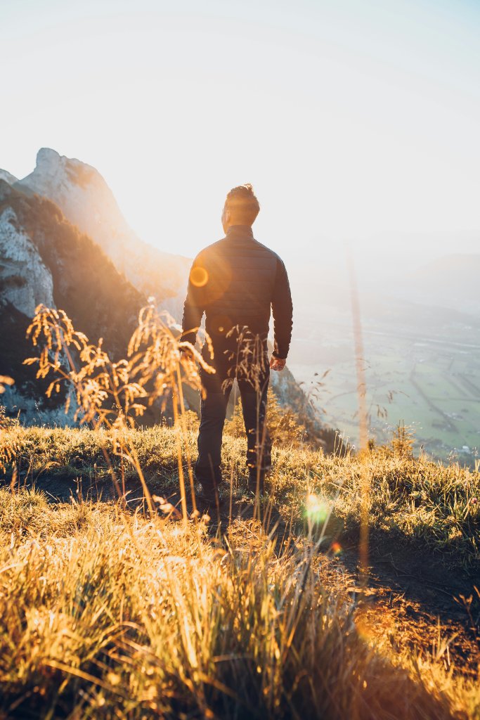 Person in a sunlit field at golden hour