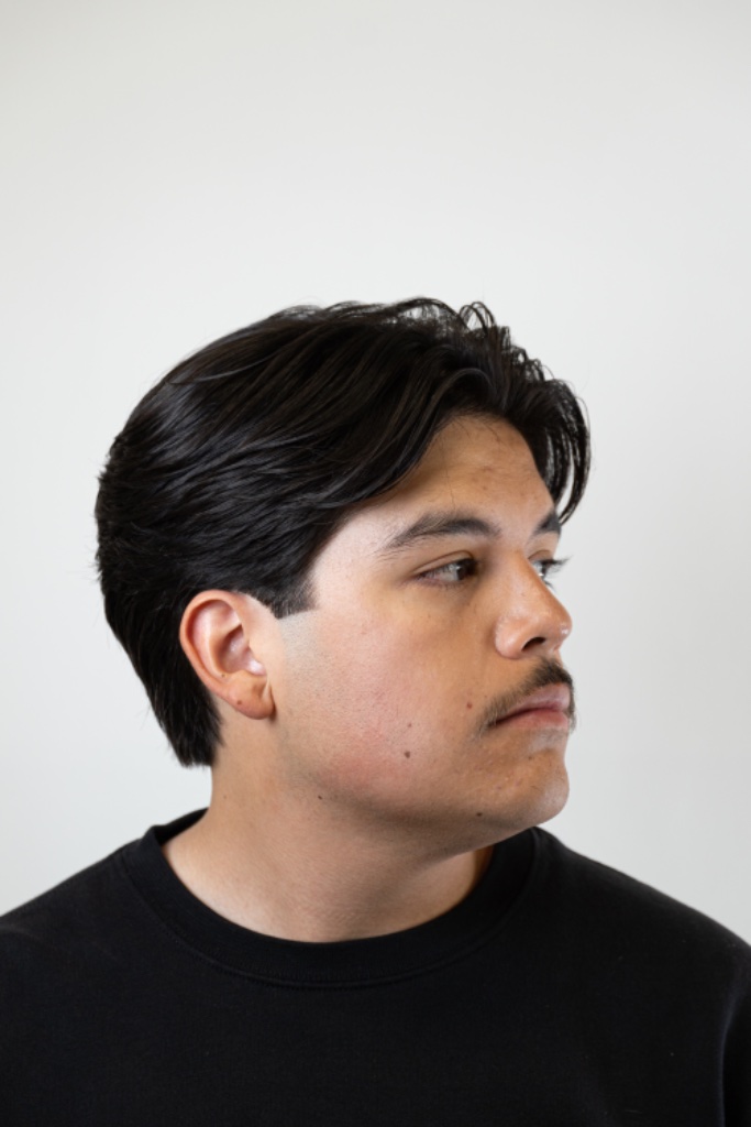 Three-quarter portrait of a center-parted straight dark style