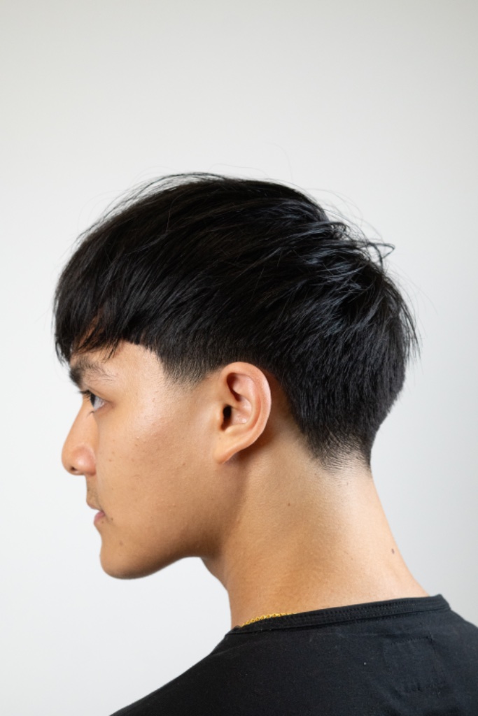 Profile shot of a taper fade with textured top and faded temples