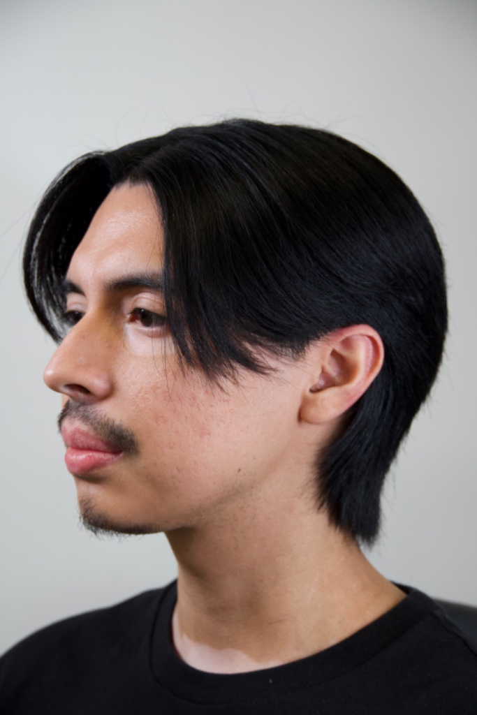Side profile of shoulder-length center-parted hair with a tapered nape