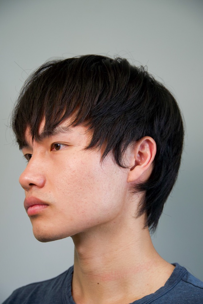 Side profile portrait with soft wispy bangs and a clean jawline