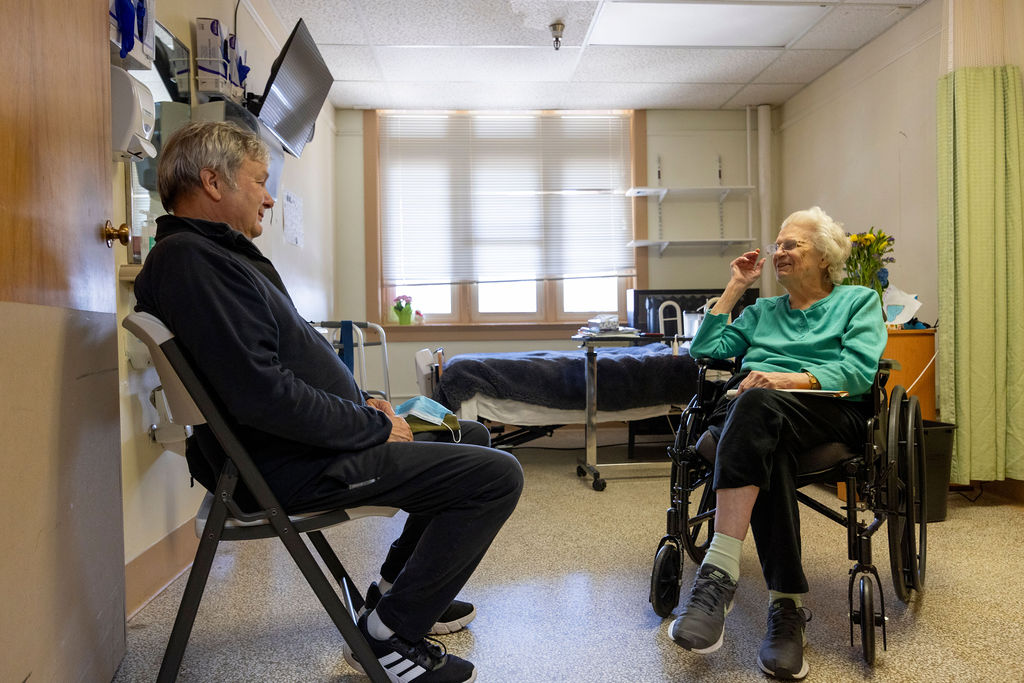 Family connection — a resident visiting with a loved one.