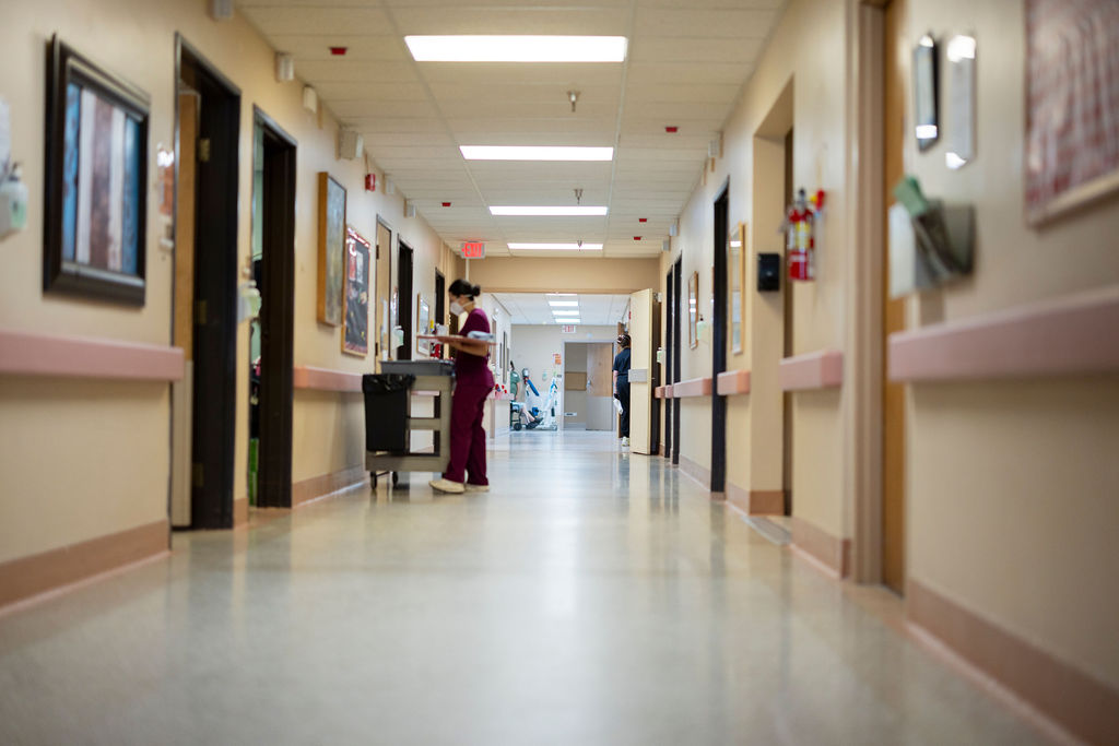 Care in motion — staff moving through the facility's corridors.