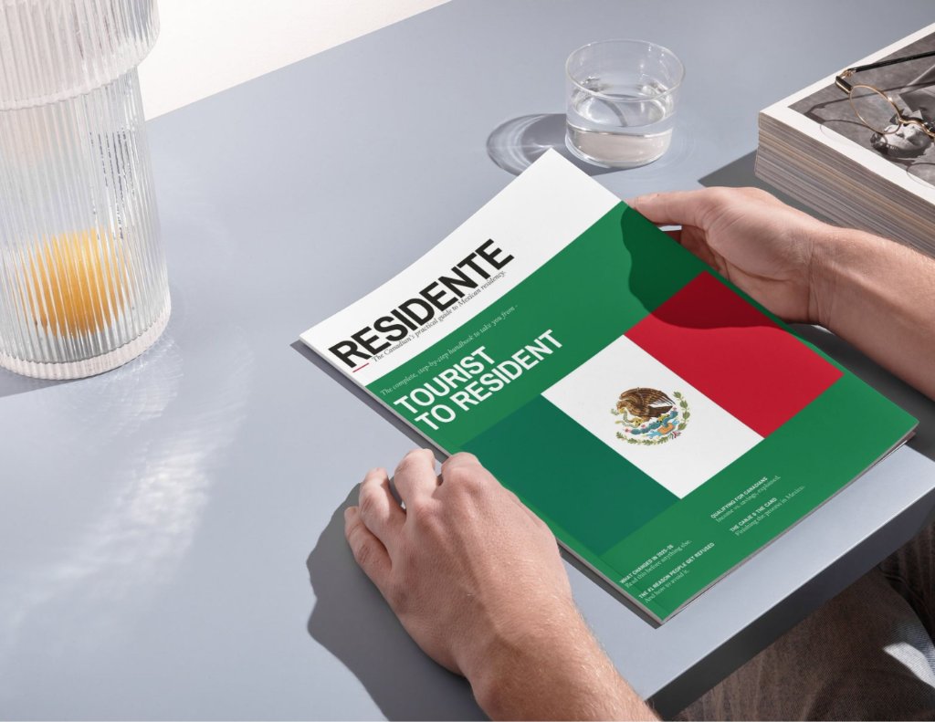 The RESIDENTE guide on a desk — a premium lifestyle photograph
