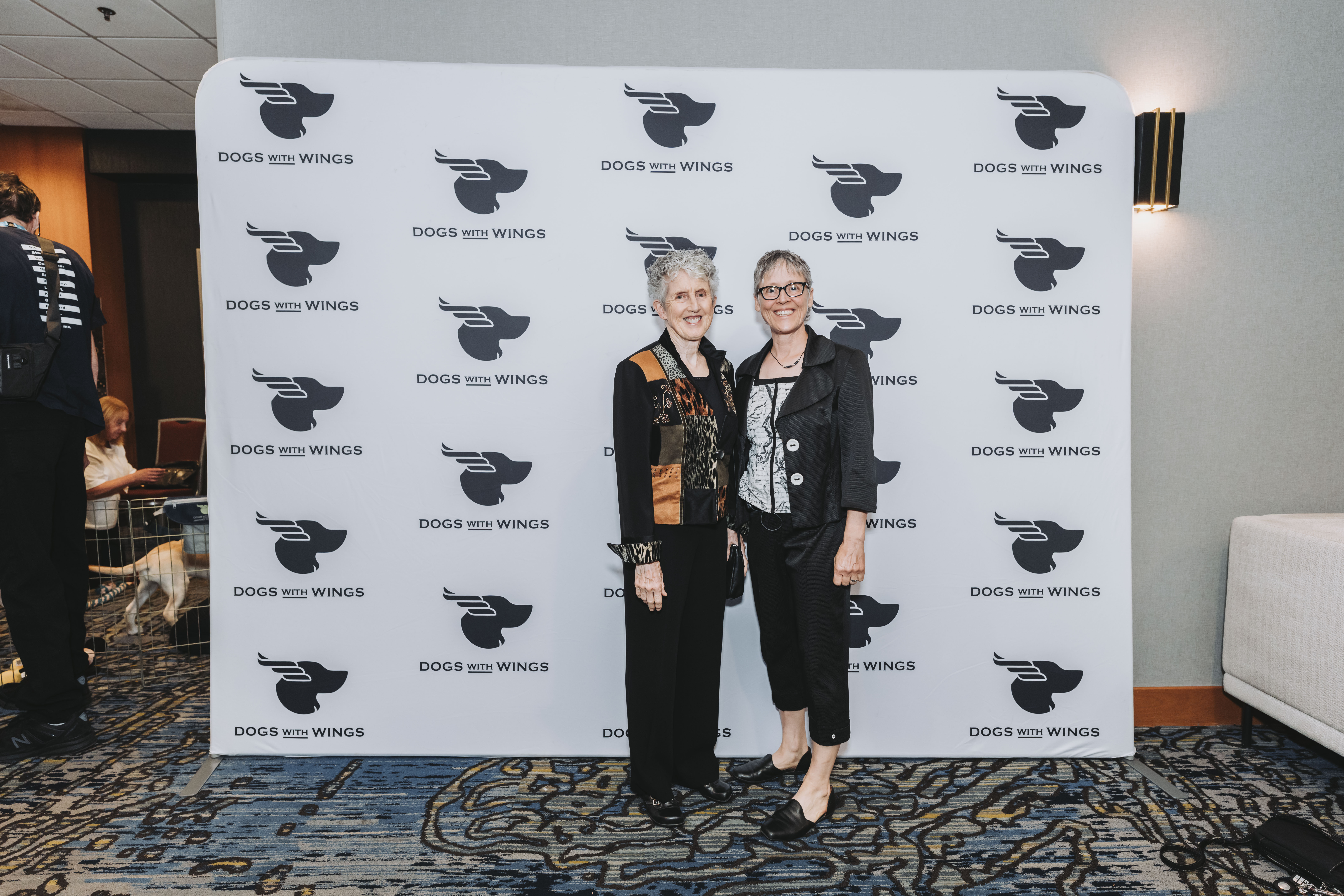 Two guests posing together at the gala step-and-repeat