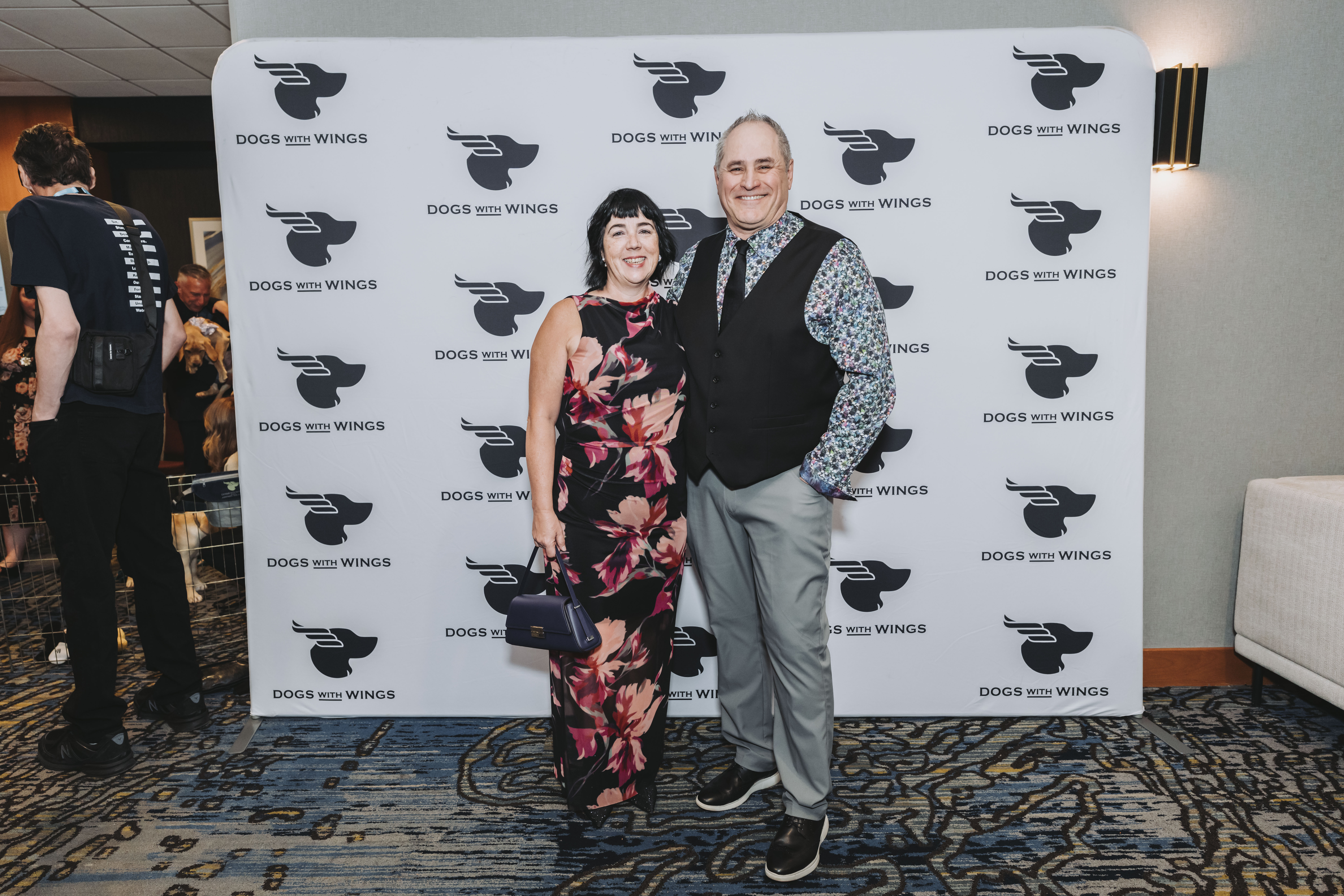 A couple in colourful florals at the step-and-repeat
