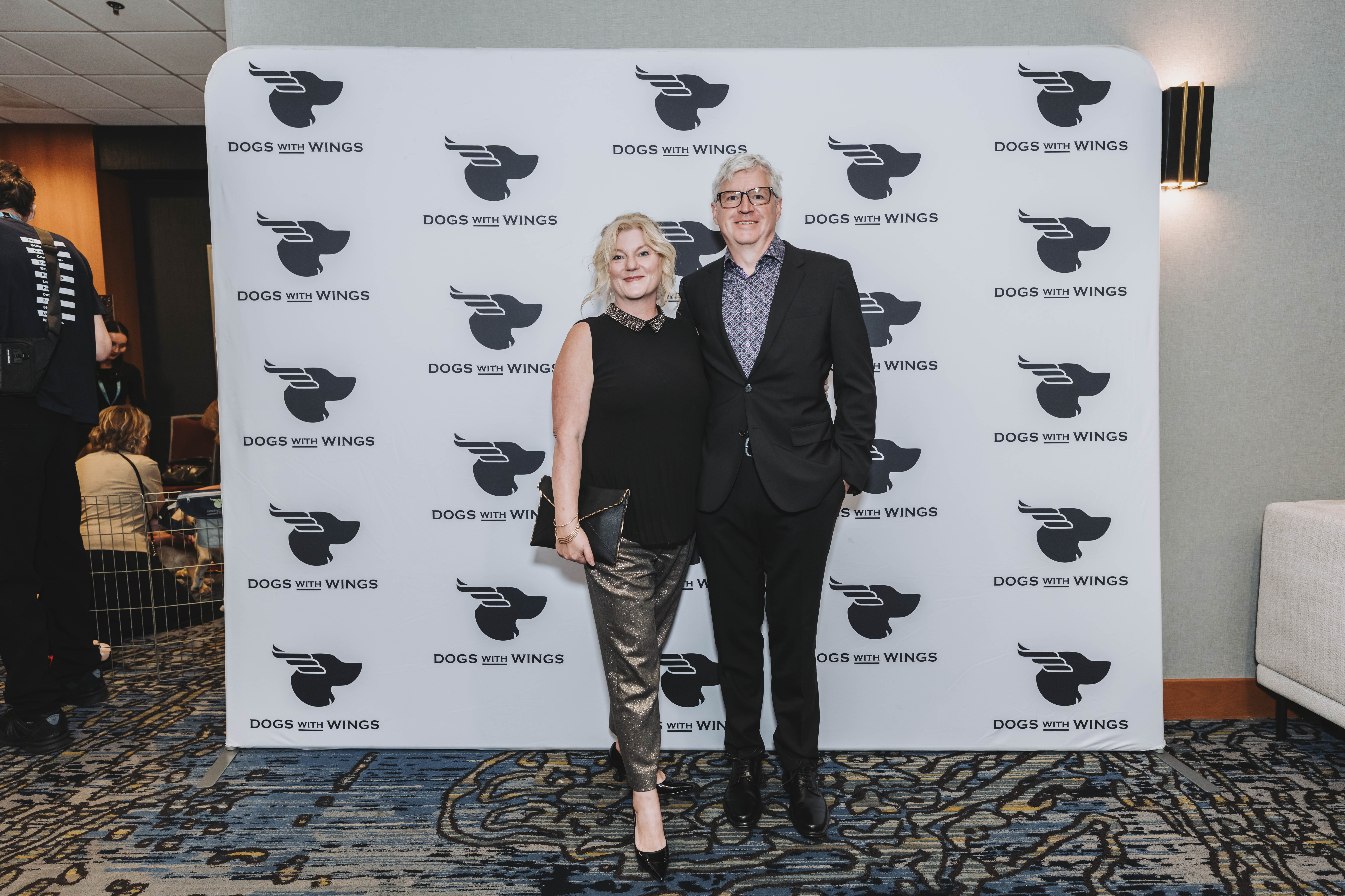 A couple dressed for the evening at the photo wall