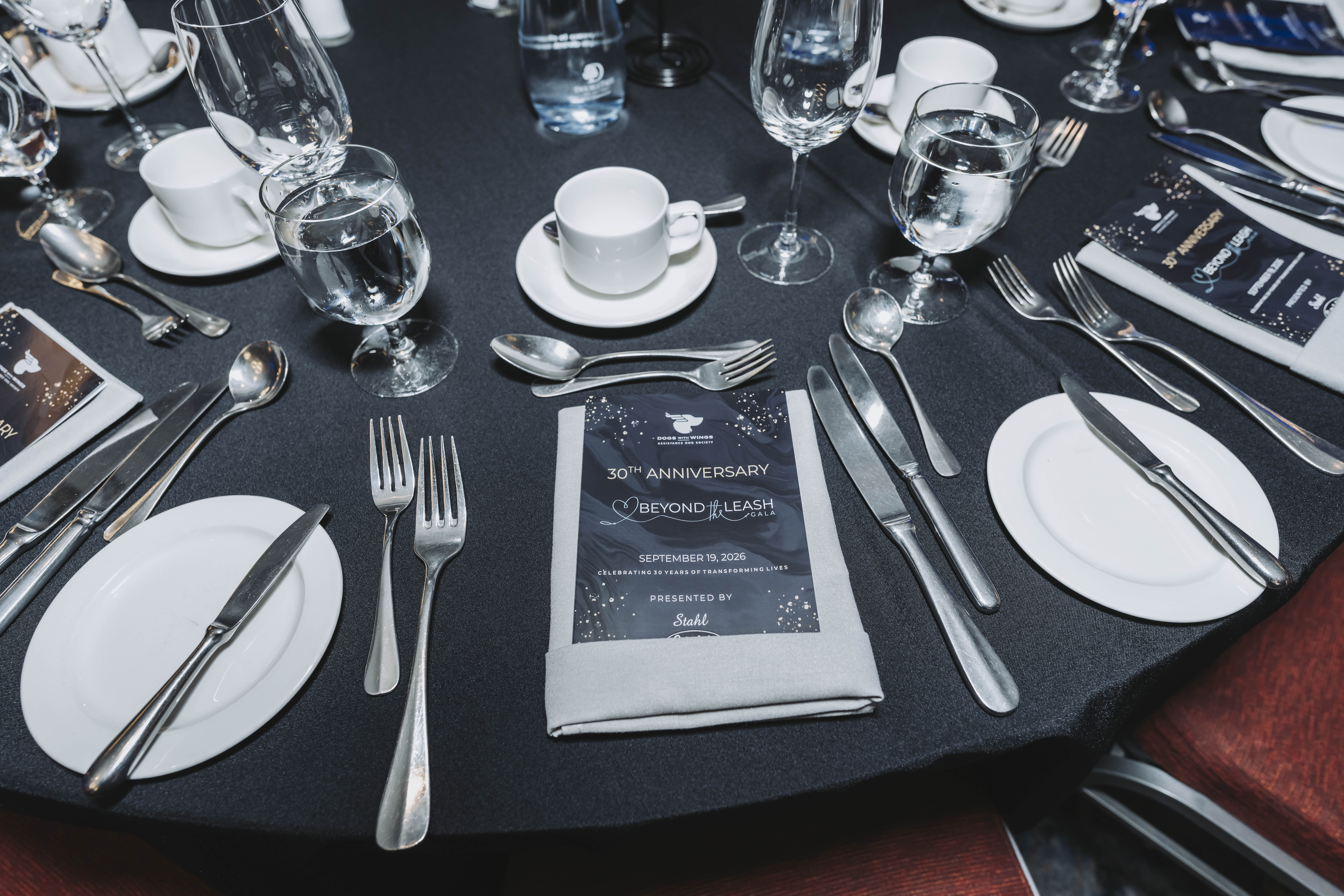 Close-up of a place setting with the 30th anniversary gala program card