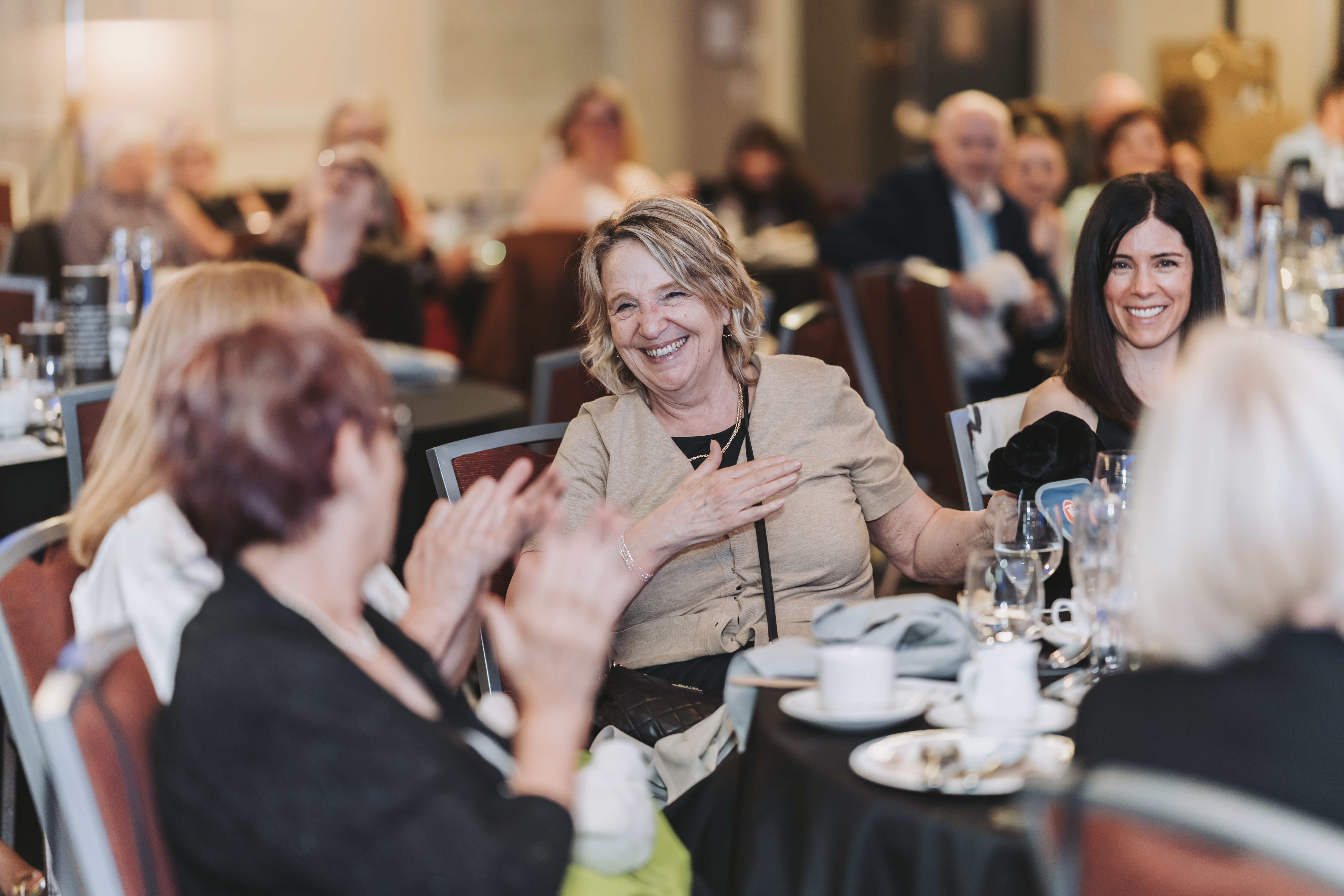 Guests applauding from their table during the gala program